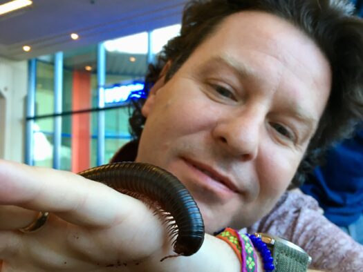Jon lets a beautiful millipede crawl over the back of his hand.