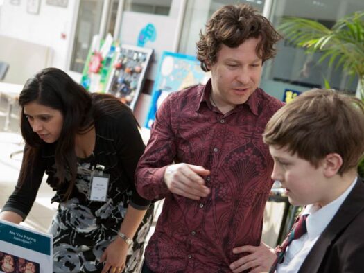 Jon talks to a young delegate at a science fair.